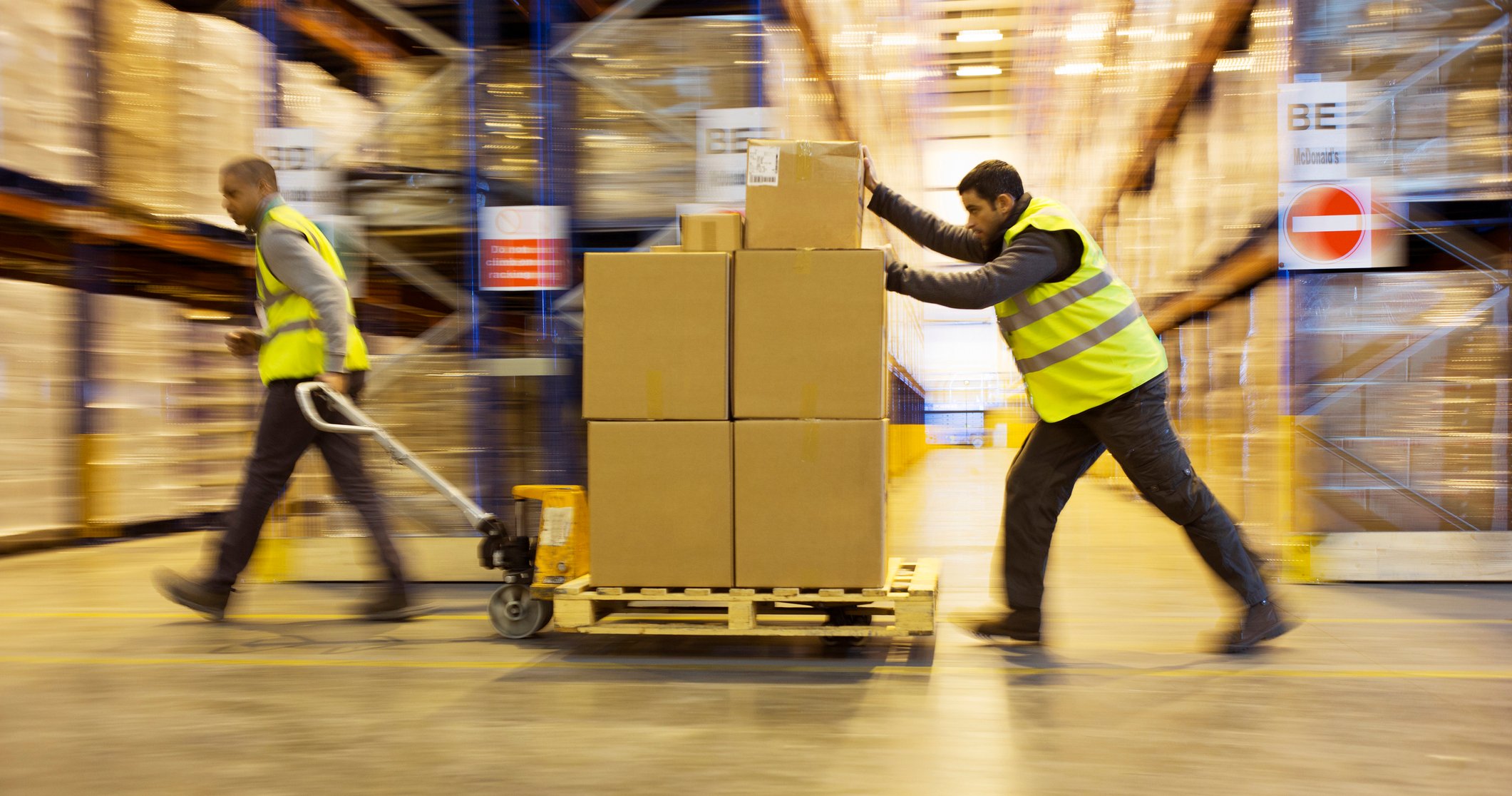 Men moving pallet of boxes.